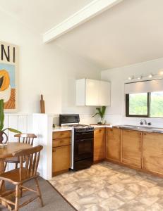 a kitchen with wooden cabinets and a stove top oven at The Ridge in Burnt Pine