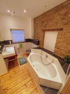 a large bathroom with a large tub and a sink at Das Haus am Bach - Schöne große moderne Wohnung mit Terrasse in Osthofen