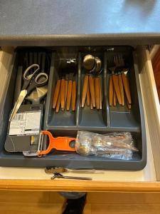 a drawer with scissors and other tools on a counter at Ovington Grove 2 fully equipped kitchen free parking 3 bedrooms Netflix in Newcastle upon Tyne