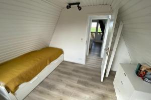 a small room with a bed in a attic at Ferienhaus Karlsson mit Blick auf die Ostsee in Hohenfelde