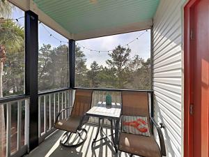 a screened in porch with a table and chairs on it at Aloha Sandy Bay in Blue Mountain Beach +66 photos