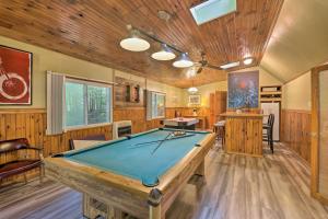 a pool table in a room with wooden walls at Arrowhead Lake Home with Game Room and Beach Access! in Pocono Lake