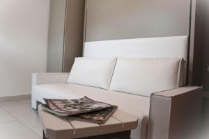 a white couch with a table in a room at Il grifo in Licata