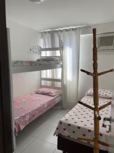 a bedroom with two bunk beds in a room at Apartamento Pajuçara in Maceió +45 photos