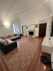 a living room with a couch and a fireplace at Casa del Poeta in Riva Ligure