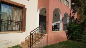 a house with a staircase next to a window at Nice tow bedrooms by snake pool for families only in Talapay in Aqaba