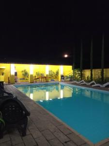 a large swimming pool at night at Hotel Ciconha in São Lourenço
