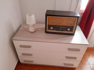 a dresser with a radio on top of it at House vittone venaria reale 2 in Venaria Reale
