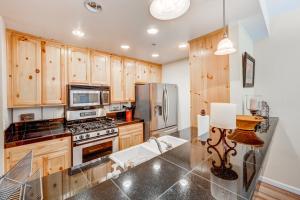 a kitchen with wooden cabinets and stainless steel appliances at Tavern Inn #39 in Olympic Valley