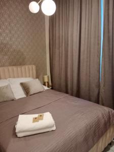 a room with two beds with a cross on a towel at Apartament Glamour Chełm in Chełm