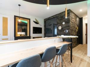 a bar with blue chairs and a stone wall at Appartement chic proche Bellecour avec parking in Lyon