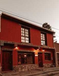 a red building with lights on top of it at La Colorada Hostal in Tilcara