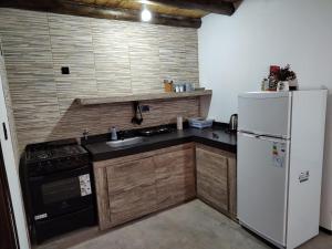 cocina con nevera blanca y fregadero en CABAÑA PEÑA D' BACO en San Rafael