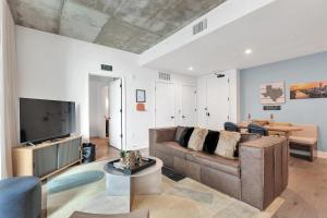 a living room with a couch and a tv at Austin Condo Hotel in Austin