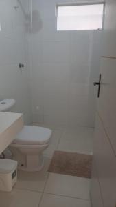 uma casa de banho branca com um WC e um lavatório em Casa Adequadra para Home-Office. em Caruaru