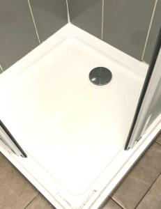 a shower with a drain in the floor of a bathroom at Private London Kensington studio 2 mins from tube in London