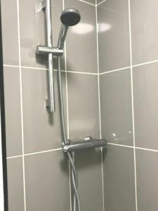 a shower with a shower head in a bathroom at Private London Kensington studio 2 mins from tube in London