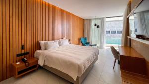 a hotel room with a bed and a desk and a desk at Radisson Beach Resort Larnaca in Larnaca +121 photos