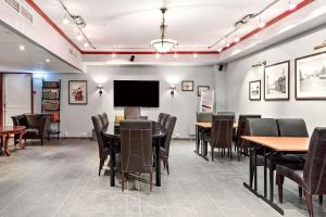 a dining room with tables and chairs and a flat screen tv at Sure Hotel by Best Western Ole Tobias in Mo i Rana