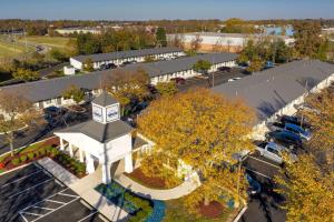 an overhead view of a parking lot with a clock tower at Suburban Studios Mentor - Cleveland Northeast in Mentor