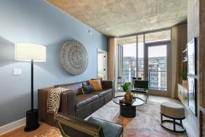 a living room with a couch and a table at Austin Condo Hotel in Austin