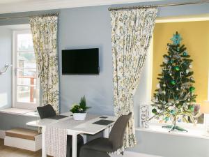 a dining room with a christmas tree and a table at Bookkeepers Place in Bakewell