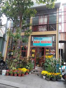 a flower shop with flowers in front of a building at Bảo Hoàng HomeStay in Con Dao
