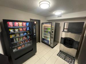 a convenience store with two refrigerators and a soda at Countryside Inn & Suites Omaha East-Council Bluffs IA in Council Bluffs