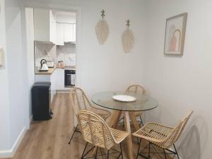 a dining room with a table and chairs in a kitchen at Stylish St. Kilda Apartment in Melbourne