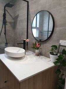 a bathroom with a sink and a mirror on a counter at Stylish St. Kilda Apartment in Melbourne +18 photos