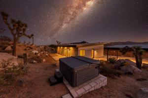 a house in the desert under a starry sky at Desert Ridge - Hot Tub, Fire Pit, BBQ, Out Door Shower & Incredi home in Yucca Valley