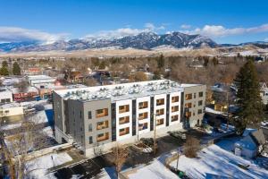 an aerial view of a building with mountains in the background at Stylish SoBo Condo - Steps to Main St in Bozeman