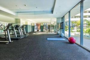 a gym with exercise equipment in a building at Pool View of Marquarie Park Paradise in Sydney