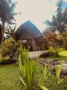a small house with a blue roof at Apit Lawang Villas & Resto in Nusa Penida