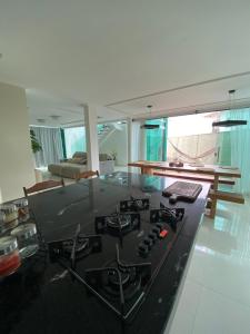 a kitchen with a stove top in a living room at Casa de luxo em condomínio in Arraial do Cabo