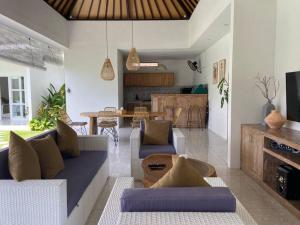 a living room with a couch and a table at Modern 3 Bedrooms Villa Beach Walking Distance in Seminyak