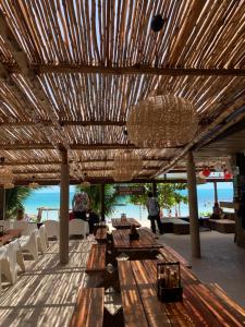 a dining area with tables and chairs and a chandelier at Silver Beach Resort in Lamai