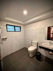 a bathroom with a toilet and a sink at Silver Beach Resort in Lamai