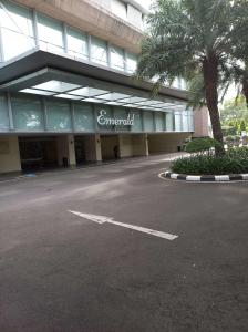 an empty parking lot in front of a building at The Mansion Kemayoran, lovely 3 bed apartment. in Jakarta