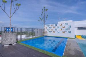 a swimming pool in front of a building at Azfa Imperio Professional Suite Alor Setar in Alor Setar