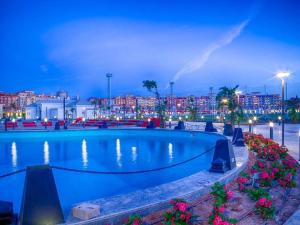 a swimming pool in a city at night at Studio in Porto Sharm in Sharm El Sheikh