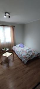a bedroom with a bed and a coffee table at departamento finas terminaciones en balneario in Puerto Montt