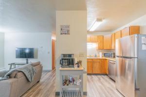 a kitchen and a living room with a refrigerator at 28th Ave Unit2 Centrally Located Coffee Bar and Comfort in Fairbanks