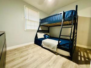 a bedroom with two bunk beds in a room at Renovated guest house in Hyattsville