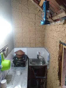 a kitchen with a sink and a pot on a stove at Little Mount Guest House in Mirissa
