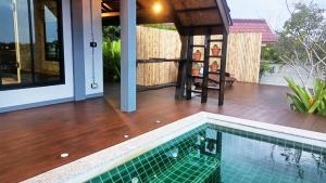 a house with a swimming pool and a patio at Rongna Villas in Ko Yao Noi