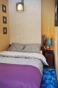 a bedroom with a bed with a wall at Apartament Numer 5 in Ustrzyki Dolne