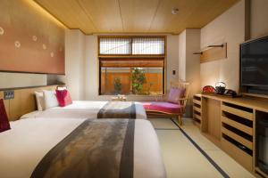 Uma cama ou camas num quarto em Onomichi Hansei