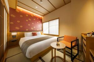 Uma cama ou camas num quarto em Onomichi Hansei