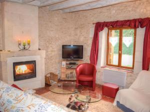 a living room with a couch and a fireplace at Gîte Chemillé-sur-Indrois, 3 pièces, 4 personnes - FR-1-381-444 in Chemillé-sur-Indrois